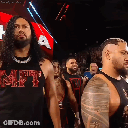 Man In Gift Shirt Stands Before Crowd GIF