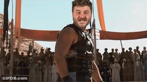 Man In Gladiator Costume In Front Of Crowd GIF