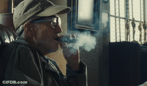 Man In Glasses And Baseball Cap Smoking Cigar GIF