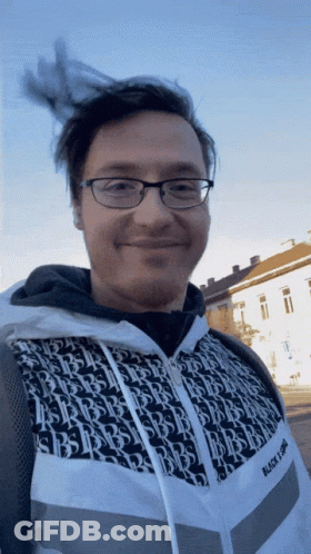 Man In Glasses And Black And White Jacket Says Black Light GIF