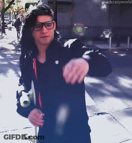 Man In Glasses And Black Jacket Walking Down Street Mad Crazy World GIF