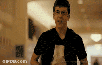 Man In Glasses And Black Shirt Holding Food Bag GIF