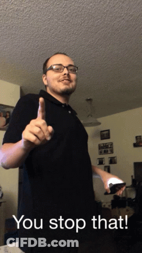 Man In Glasses And Black Shirt Holding Remote Saying You Stop That GIF