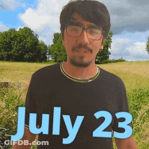 Man In Glasses And Black Shirt In Field On July 23 GIF