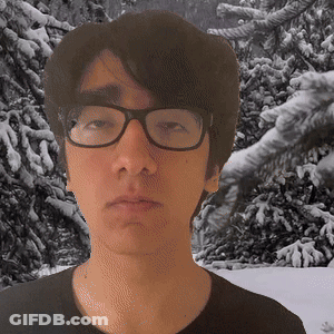 Man In Glasses And Black Shirt In Snowy Trees GIF