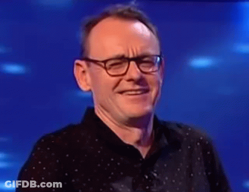 Man In Glasses And Black Shirt Laughing GIF