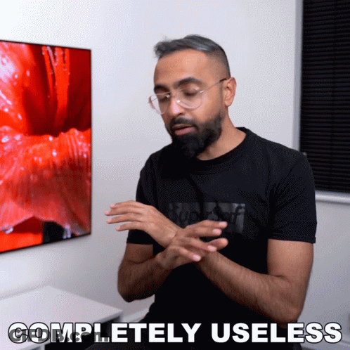 Man In Glasses And Black Shirt Saying Completely Useless GIF