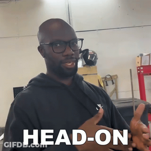 Man In Glasses And Black Shirt Saying Head-On GIF