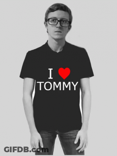 Man In Glasses And Black Shirt Saying I Heart Tommy GIF