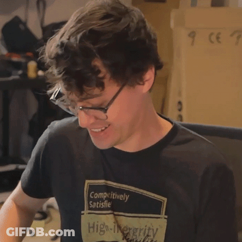 Man In Glasses And Black Shirt Saying Outrageous GIF