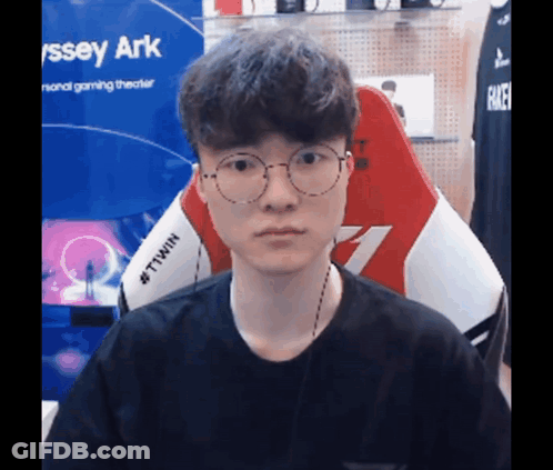 Man In Glasses And Black Smiley Shirt Eating GIF