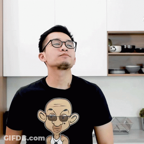 Man In Glasses And Black T-Shirt With Cartoon Man GIF