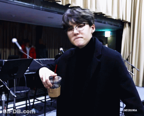 Man In Glasses And Black Turtleneck Holding Coffee With Straw GIF