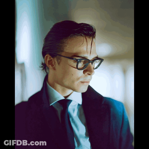 Man In Glasses And Blue Coat Looking To Side GIF