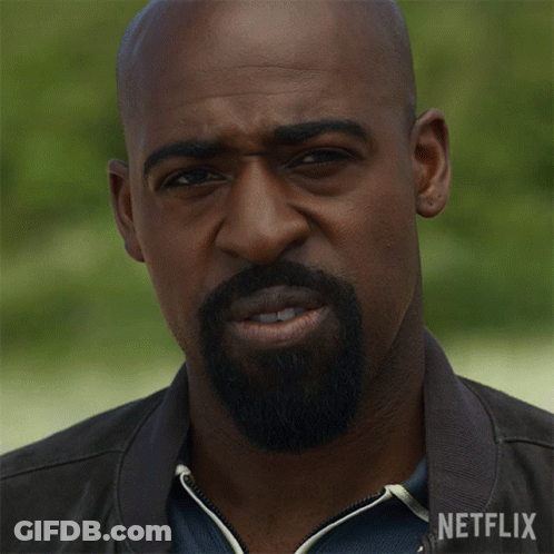 Man In Glasses And Blue Jacket Looking At Camera GIF