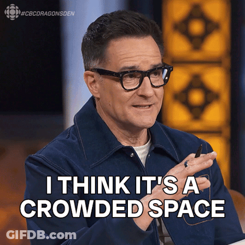 Man In Glasses And Blue Jacket Saying I Think It's A Crowded Space GIF