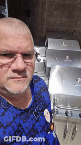 Man In Glasses And Blue Rock Shirt At Grill GIF