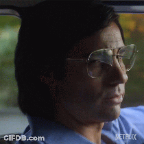 Man In Glasses And Blue Shirt Driving Car With Netflix GIF