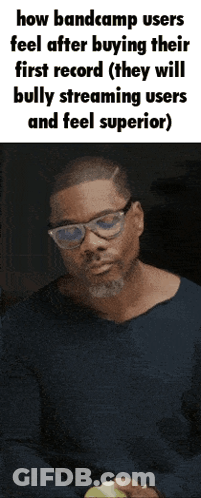 Man In Glasses And Blue Shirt Holding Green Apple GIF
