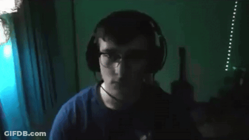 Man In Glasses And Blue Shirt Looking At Camera GIF
