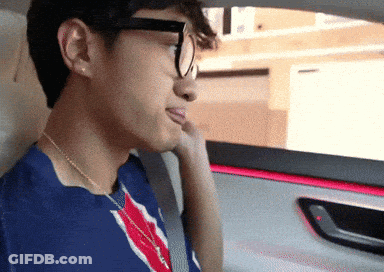 Man In Glasses And Blue Shirt Looking Out Car Window GIF
