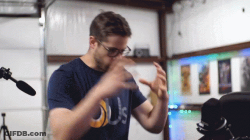 Man In Glasses And Blue Shirt Saying Us GIF