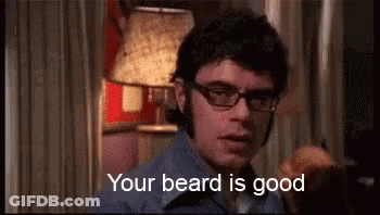 Man In Glasses And Blue Shirt Saying Your Beard Is Good GIF