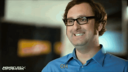 Man In Glasses And Blue Shirt Smiling Saying Oh GIF