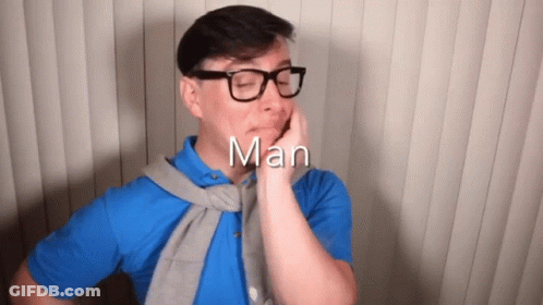 Man In Glasses And Blue Shirt With Word Man Above GIF