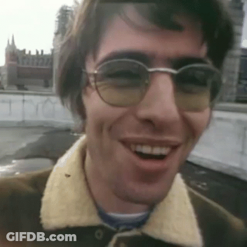 Man In Glasses And Brown Jacket Smiling GIF