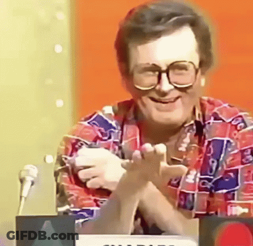 Man In Glasses And Colorful Shirt At Microphone GIF