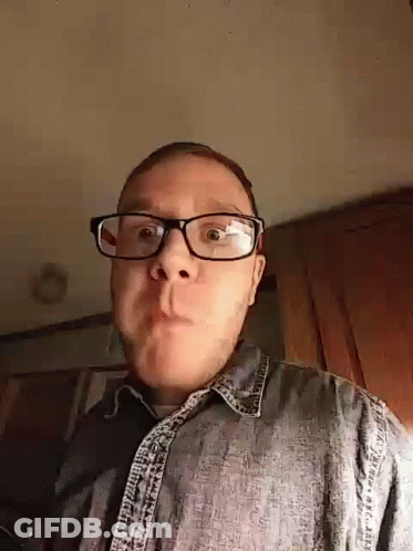 Man In Glasses And Denim Shirt Making A Face GIF