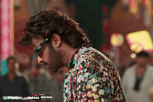 Man In Glasses And Floral Shirt Listening To Pranay Varma On YouTube Music GIF