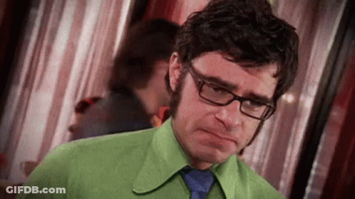 Man In Glasses And Green Shirt Making Sad Face GIF