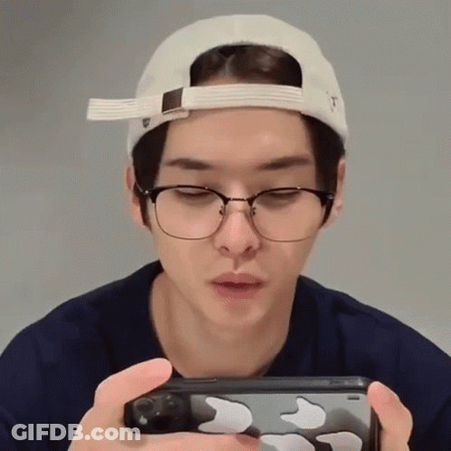 Man In Glasses And Hat Holding Cell Phone GIF