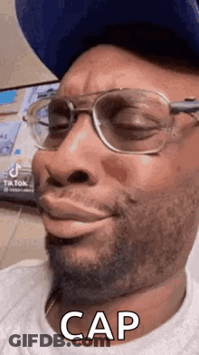 Man In Glasses And Hat Making Funny Face Saying Cap GIF