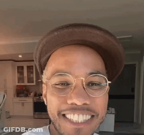 Man In Glasses And Hat Smiling In Kitchen GIF