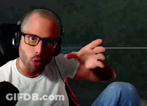 Man In Glasses And Headphones Making Funny Face On Couch GIF
