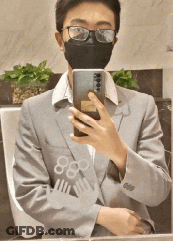 Man In Glasses And Mask Taking Selfie In Mirror GIF