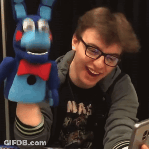 Man In Glasses And NBA Shirt Smiling With Stuffed Animal GIF