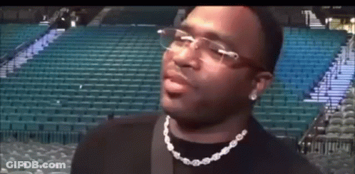 Man In Glasses And Necklace At Stadium GIF