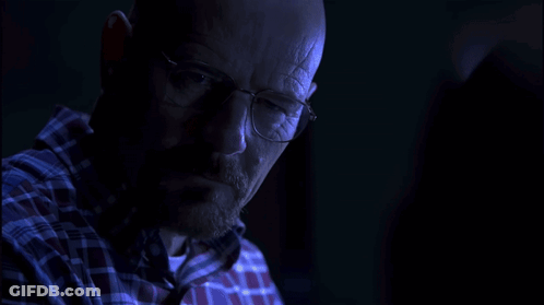 Man In Glasses And Plaid Shirt Looking In Dark GIF