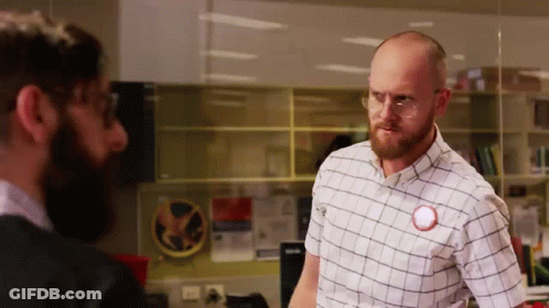 Man In Glasses And Plaid Shirt With Red Circle On Shirt GIF