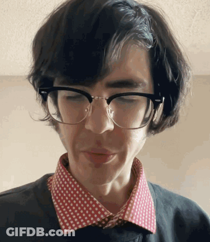 Man In Glasses And Polka Dot Shirt Looking Down GIF