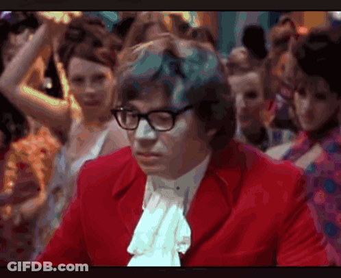 Man In Glasses And Red Jacket Before Crowd GIF