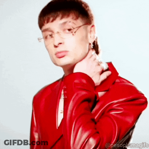 Man In Glasses And Red Jacket Looking At Camera GIF