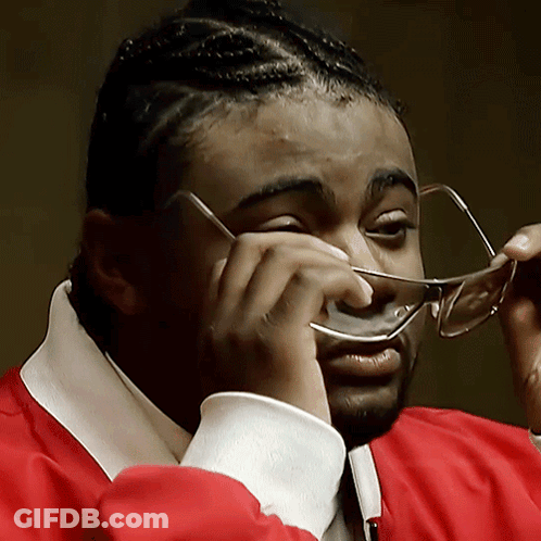 Man In Glasses And Red Jacket Wiping Nose GIF