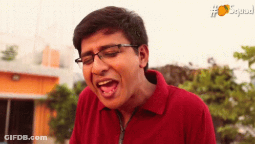 Man In Glasses And Red Shirt Making Funny Face With Squad GIF