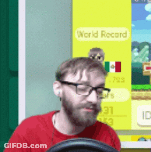 Man In Glasses And Red Shirt Playing Video Game With World Record GIF