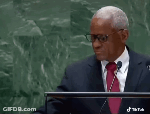 Man In Glasses And Red Tie Giving Speech At Podium GIF